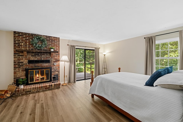 2035 Lee Jackson Hwy, Staunton, VA 24401 - bedroom featuring access to exterior, wood finished floors, and a brick fireplace