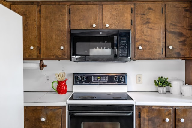 2035 Lee Jackson Hwy, Staunton, VA 24401 - kitchen with black appliances, light countertops, and dark brown cabinetry