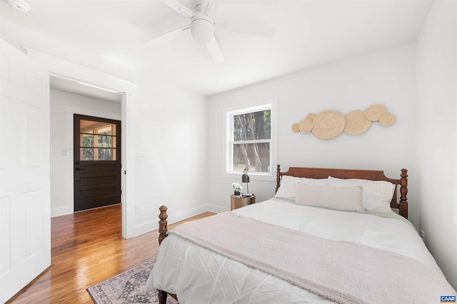 1867 Stage Junction Rd, Columbia, VA 23038 - bedroom with light wood-type flooring, multiple windows, baseboards, and a ceiling fan