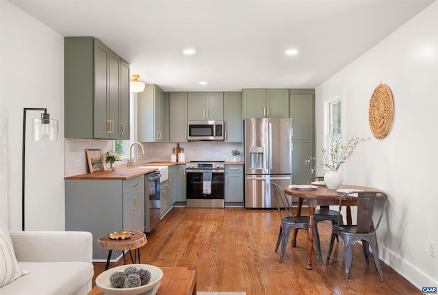1867 Stage Junction Rd, Columbia, VA 23038 - kitchen featuring appliances with stainless steel finishes, green cabinetry, backsplash, and recessed lighting