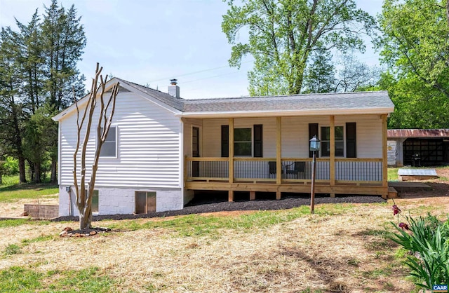 1867 Stage Junction Rd, Columbia, VA 23038 - back of house featuring covered porch, roof with shingles, and a chimney