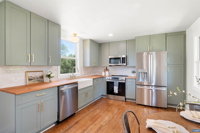 1867 Stage Junction Rd, Columbia, VA 23038 - kitchen with appliances with stainless steel finishes, wood counters, a sink, green cabinets, and recessed lighting