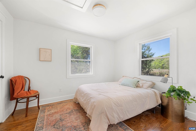 1867 Stage Junction Rd, Columbia, VA 23038 - bedroom featuring baseboards, wood finished floors, and a skylight