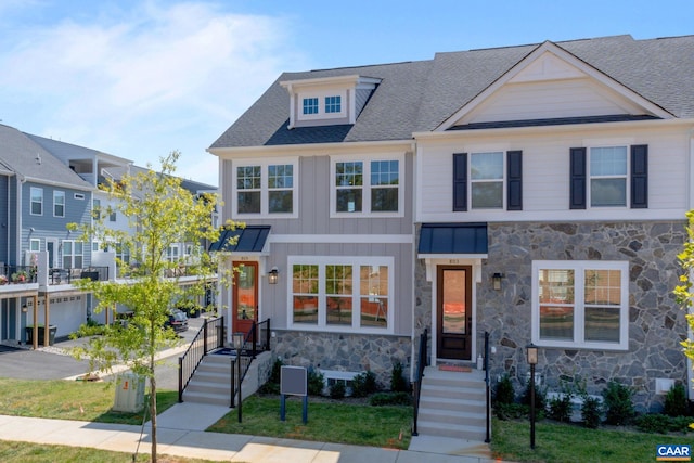 9 Woodburn Rd, Charlottesville, VA 22901 - view of front of home with stone siding, a shingled roof, and board and batten siding