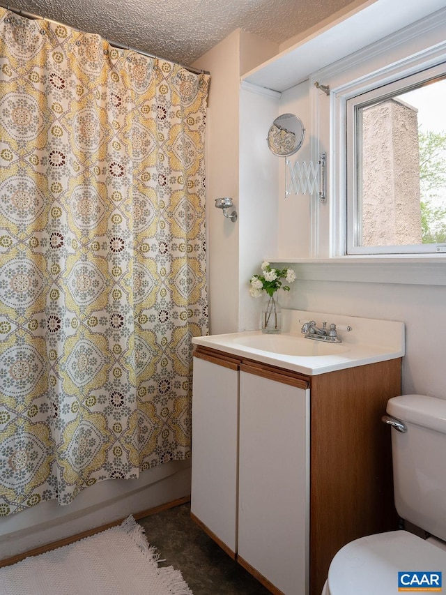 bathroom with toilet, vanity, and shower / tub combo with curtain