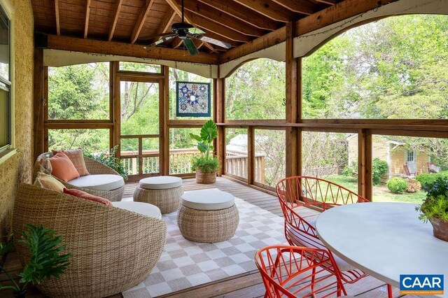 sunroom with a ceiling fan, lofted ceiling, and wood finished floors