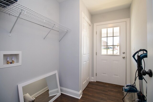washroom featuring laundry area, dark wood finished floors, baseboards, and hookup for a washing machine