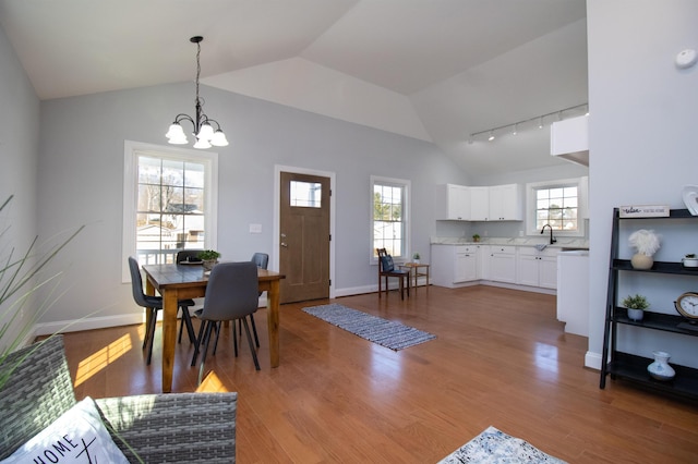 515A Grubert Ave, Staunton, VA 24401 - dining room featuring lofted ceiling, a chandelier, light wood finished floors, baseboards, and track lighting