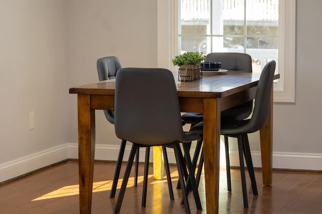 dining space featuring plenty of natural light, baseboards, and wood finished floors