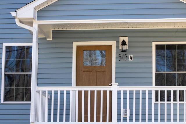 view of exterior entry with a porch