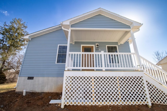 back of property with a porch