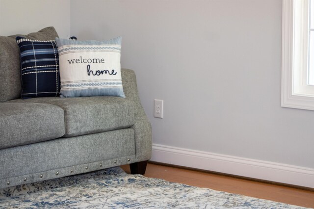 sitting room featuring baseboards and wood finished floors