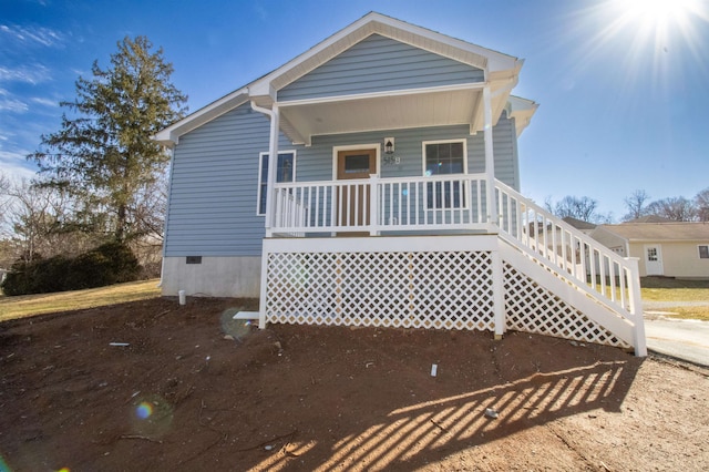 view of front of house featuring covered porch and crawl space