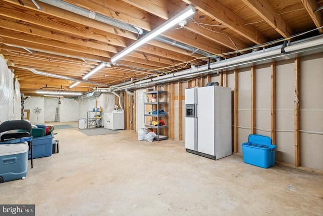  - unfinished basement featuring white fridge with ice dispenser and washer / dryer