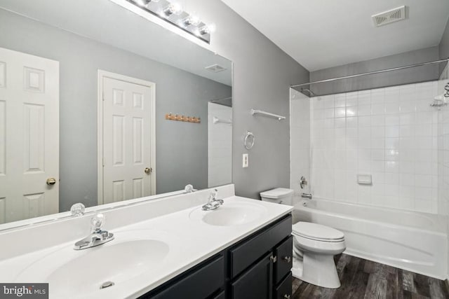  - full bathroom featuring wood finished floors, double vanity, and tub / shower combination