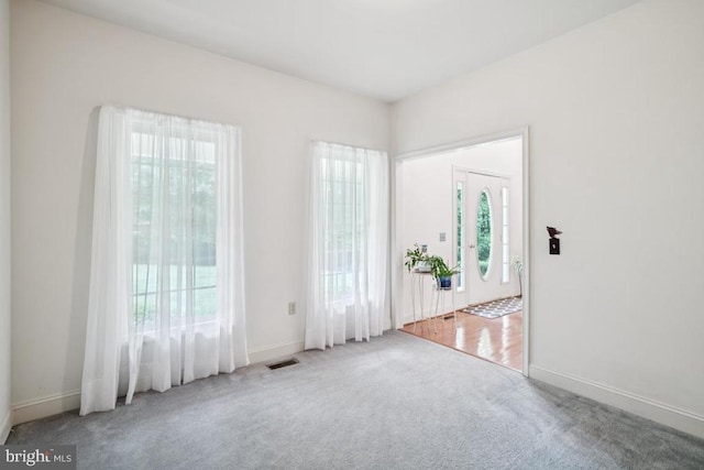  - carpeted empty room featuring baseboards