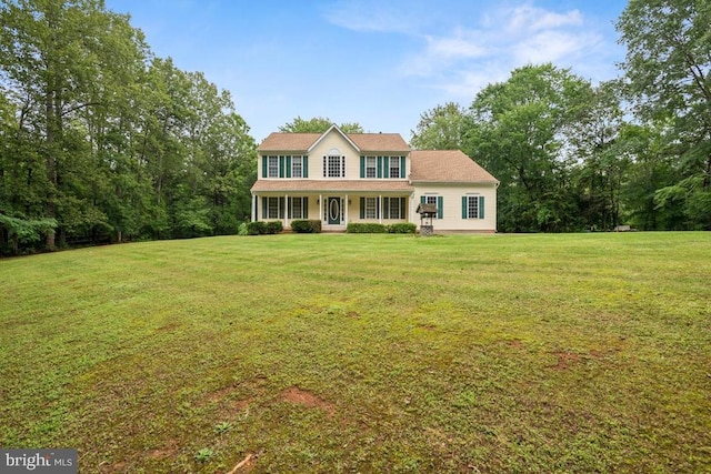  - colonial home with a front yard and a porch