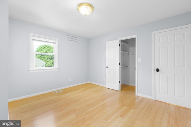 12218 Corter Ave, Fredericksburg, VA 22407 - unfurnished bedroom with light wood finished floors and a spacious closet