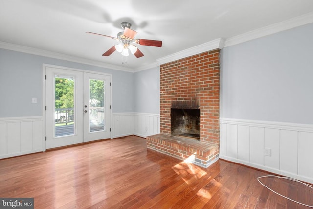 12218 Corter Ave, Fredericksburg, VA 22407 - unfurnished living room featuring wood finished floors, ceiling fan, wainscoting, crown molding, and a fireplace