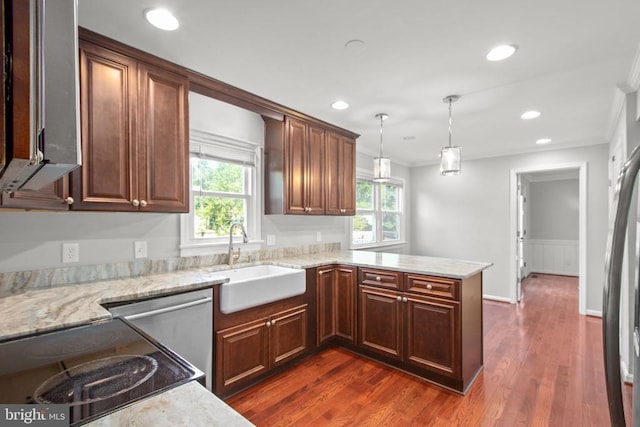 12218 Corter Ave, Fredericksburg, VA 22407 - kitchen with crown molding, a peninsula, dark wood finished floors, light stone counters, and hanging light fixtures