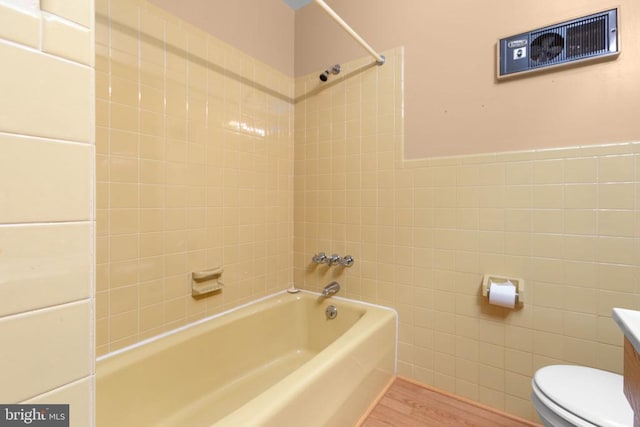 8305 Old Plank Rd, Fredericksburg, VA 22407 - full bathroom featuring tile walls, wood finished floors, bathing tub / shower combination, and vanity