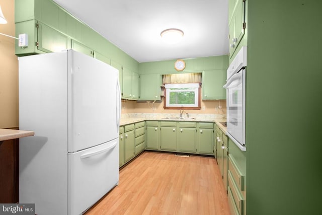 8305 Old Plank Rd, Fredericksburg, VA 22407 - kitchen featuring green cabinetry, white appliances, light wood finished floors, and light countertops