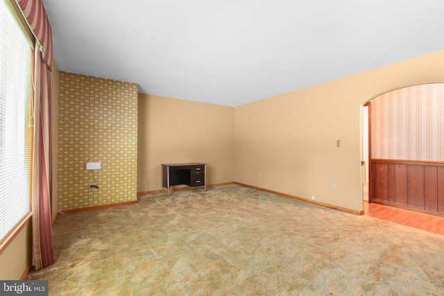 8305 Old Plank Rd, Fredericksburg, VA 22407 - unfurnished living room featuring carpet, arched walkways, and wallpapered walls