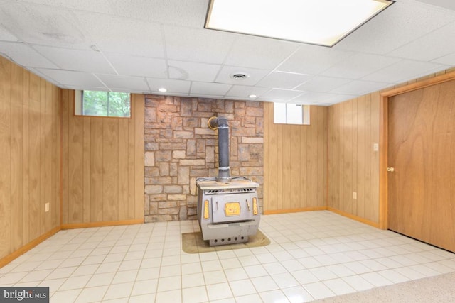 8305 Old Plank Rd, Fredericksburg, VA 22407 - basement featuring wood walls, a paneled ceiling, and a wood stove