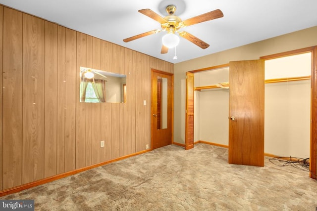 8305 Old Plank Rd, Fredericksburg, VA 22407 - unfurnished bedroom with carpet, multiple closets, ceiling fan, and wooden walls