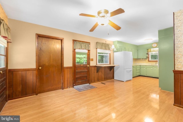 8305 Old Plank Rd, Fredericksburg, VA 22407 - kitchen with green cabinets, freestanding refrigerator, a wainscoted wall, light wood-type flooring, and ceiling fan