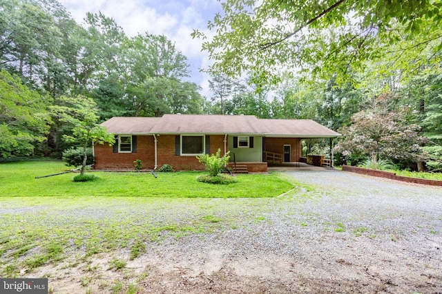 8305 Old Plank Rd, Fredericksburg, VA 22407 - ranch-style home featuring driveway, an attached carport, a front lawn, and brick siding