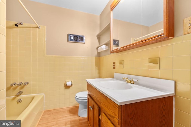 8305 Old Plank Rd, Fredericksburg, VA 22407 - bathroom with tile walls, vanity, wood finished floors, and washtub / shower combination