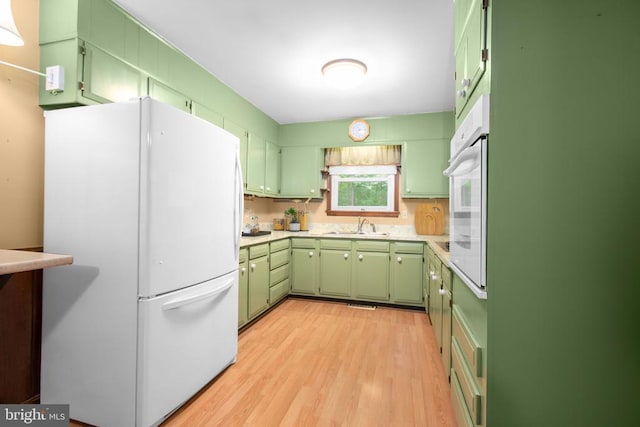 8305 Old Plank Rd, Fredericksburg, VA 22407 - kitchen with green cabinets, white appliances, light countertops, and light wood-style flooring