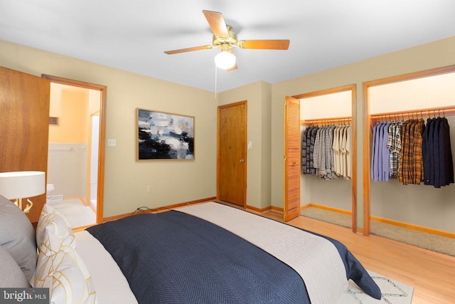 8305 Old Plank Rd, Fredericksburg, VA 22407 - bedroom featuring two closets, wood finished floors, and ceiling fan