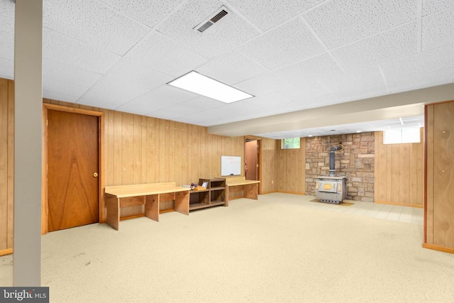 8305 Old Plank Rd, Fredericksburg, VA 22407 - unfurnished office with a wood stove, wooden walls, carpet flooring, and a drop ceiling