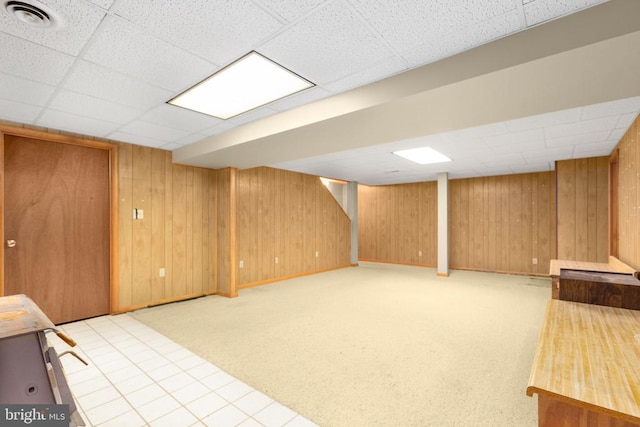8305 Old Plank Rd, Fredericksburg, VA 22407 - finished basement with a paneled ceiling, wood walls, and light colored carpet