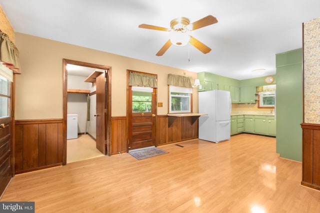 8305 Old Plank Rd, Fredericksburg, VA 22407 - unfurnished living room with a wainscoted wall, light wood-style flooring, ceiling fan, and wood walls