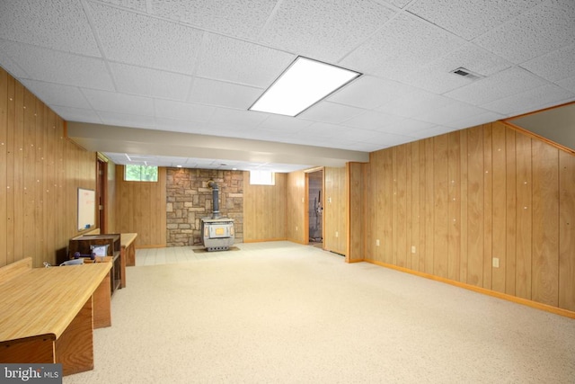 8305 Old Plank Rd, Fredericksburg, VA 22407 - basement with a wood stove, wood walls, and carpet