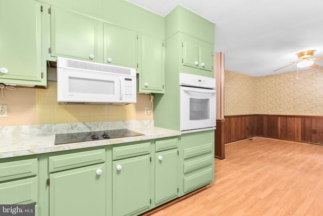 8305 Old Plank Rd, Fredericksburg, VA 22407 - kitchen featuring white appliances, light countertops, light wood finished floors, a ceiling fan, and a wainscoted wall