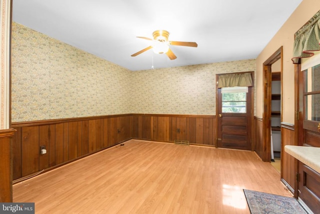 8305 Old Plank Rd, Fredericksburg, VA 22407 - unfurnished room with a wainscoted wall, a ceiling fan, light wood-style floors, and wood walls