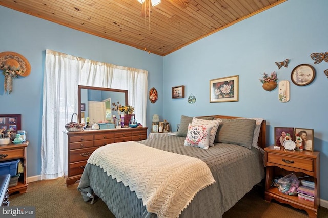 carpeted bedroom featuring lofted ceiling, baseboards, wood ceiling, and crown molding