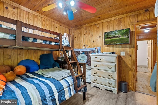 bedroom featuring wood walls, wood ceiling, and wood finished floors