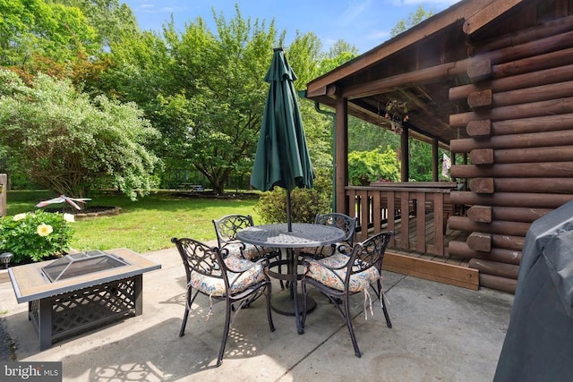 view of patio / terrace with outdoor dining area and a fire pit