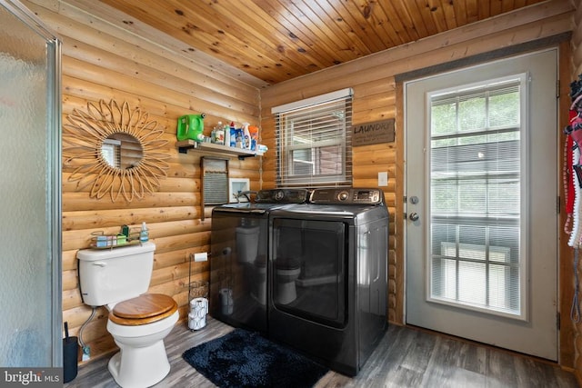 laundry room featuring log walls, independent washer and dryer, wooden ceiling, and wood finished floors