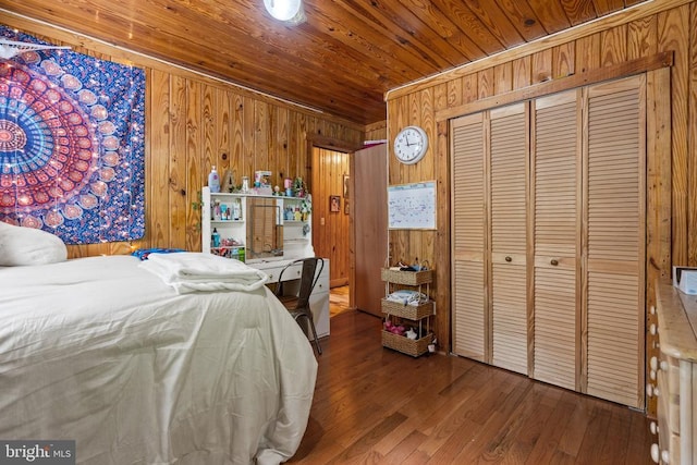 bedroom featuring wood walls, hardwood / wood-style floors, wood ceiling, and a closet