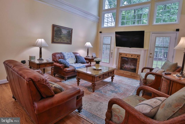 13608 General Slocum Ct S, Fredericksburg, VA 22407 - living area with a tiled fireplace, wood finished floors, a high ceiling, and ornamental molding