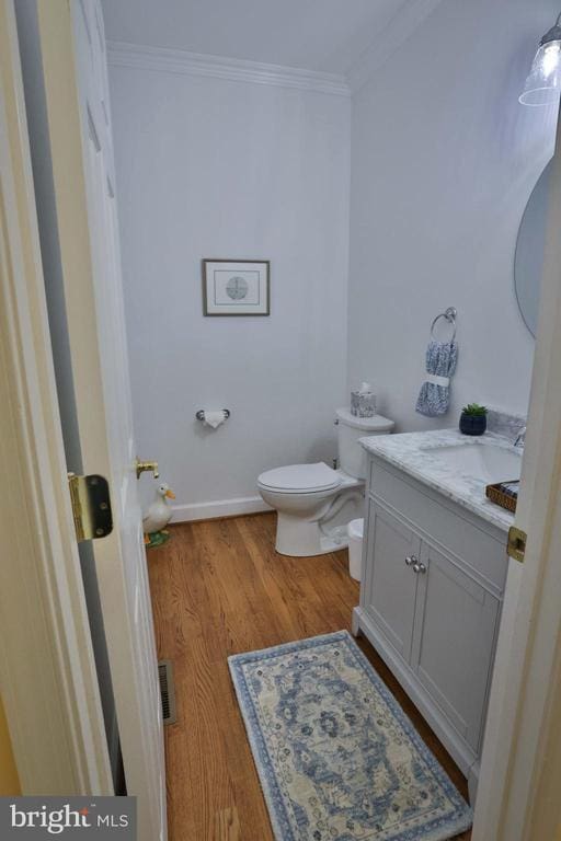 13608 General Slocum Ct S, Fredericksburg, VA 22407 - half bathroom featuring vanity, ornamental molding, and wood finished floors