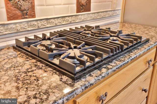 13608 General Slocum Ct S, Fredericksburg, VA 22407 - kitchen view of stainless steel gas stovetop, decorative backsplash, and stone counters