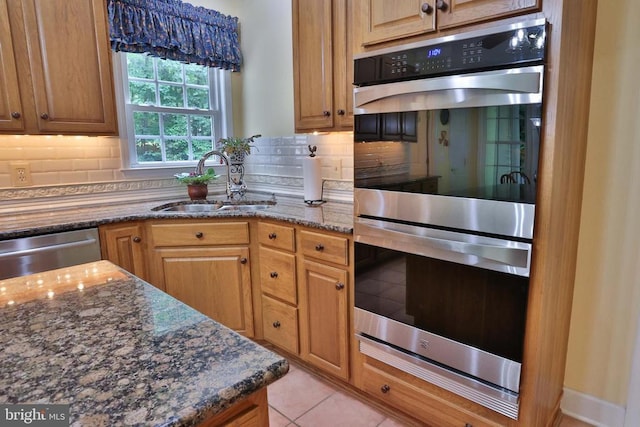 13608 General Slocum Ct S, Fredericksburg, VA 22407 - kitchen with stainless steel appliances, backsplash, dark stone counters, and light tile patterned floors