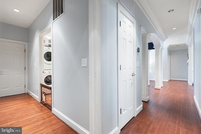 11259 Pimlico Cir, Culpeper, VA 22701 - hall with stacked washing machine and dryer, ornate columns, crown molding, wood finished floors, and baseboards